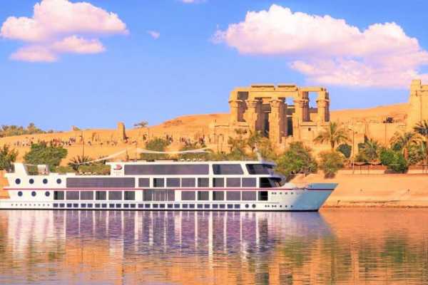 Nile cruise ship sailing at sunset near Luxor